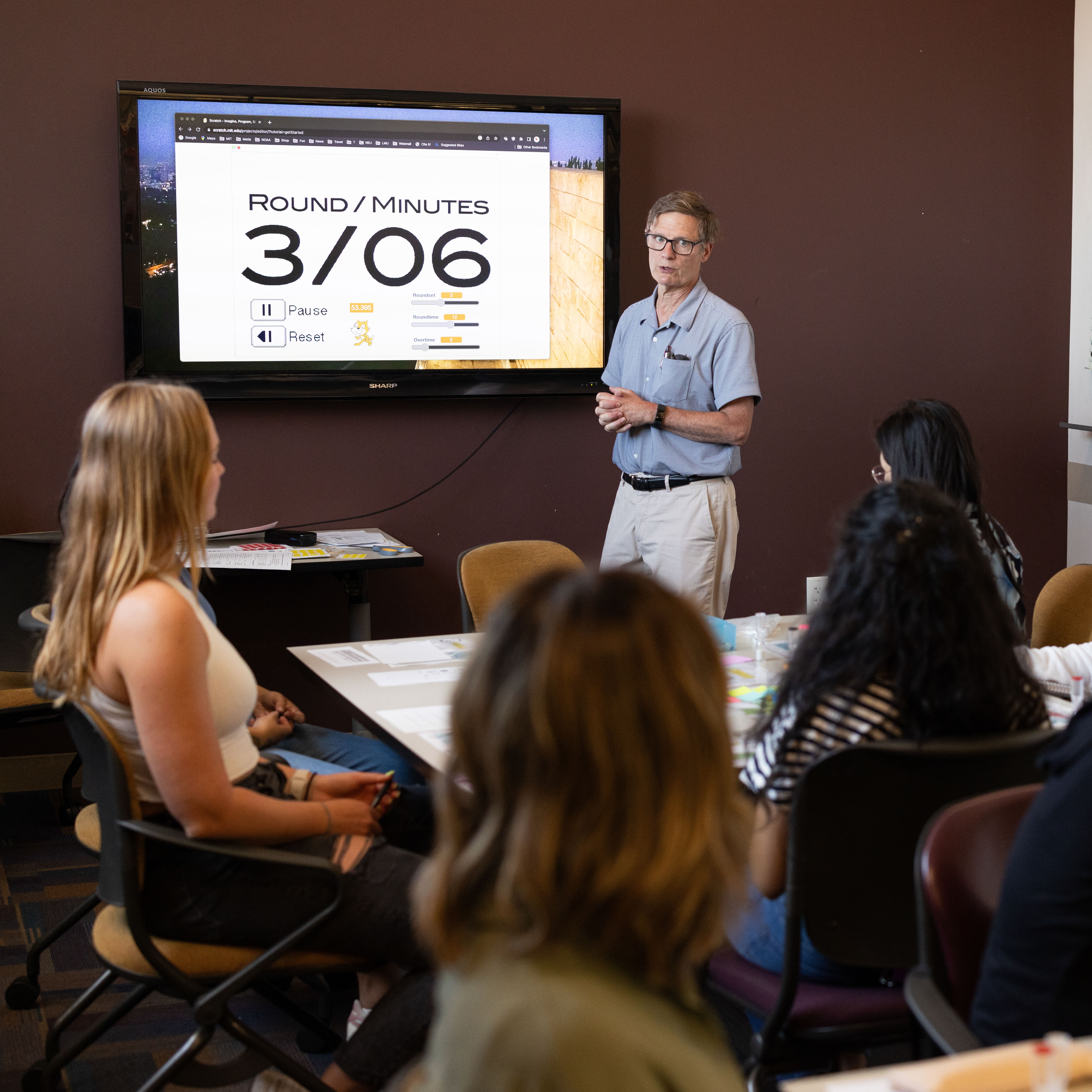 Classroom with grad students, the professor is leading the class